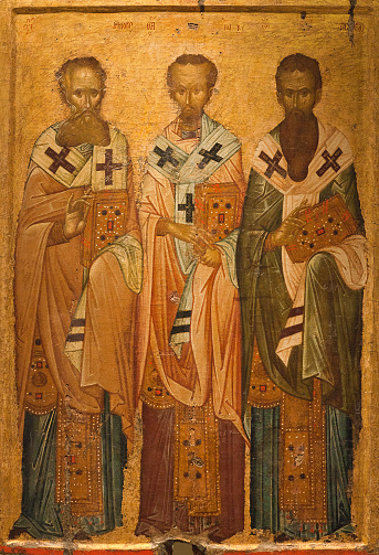 Thessaloniki, Greece - March 17, 2018: Ancient icon of Church Fathers from the church of Holy Trinity, 14th cent. The Three Hierarchs - Basil the Great,  Gregory the Theologian and John Chrysostom.