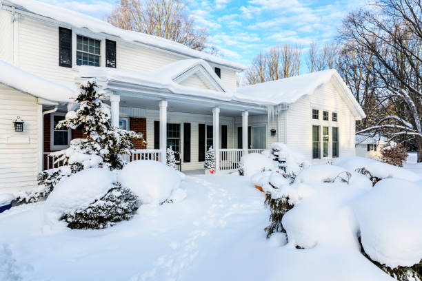 istock Early Morning Sunshine Colonial Style Home After Extreme Blizzard Snow Storm 1293211237