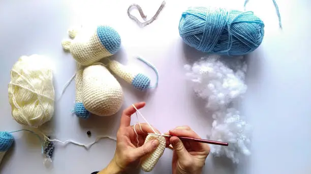 process and materials for crocheting handmade unicorn toy.