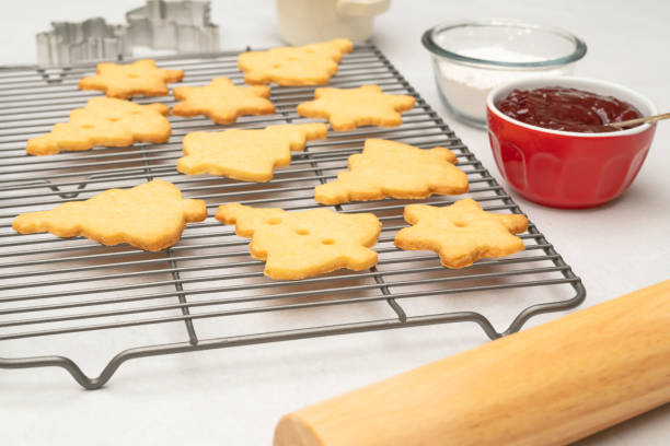 istock Classic Shortbread cookies with raspberry preserves recipe. Cookies close up on cooling rack, close up baking process 1293214115