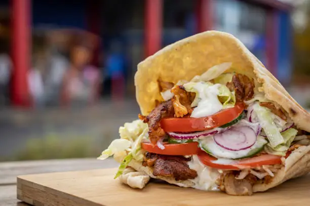 Doner Kebab at a local street food stall on wooden cutting board