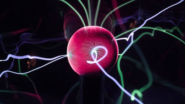 istock View of plasma ball with moving energy rays inside on black background. Abstract lightning in colors. Electricity in gas. 1293225407
