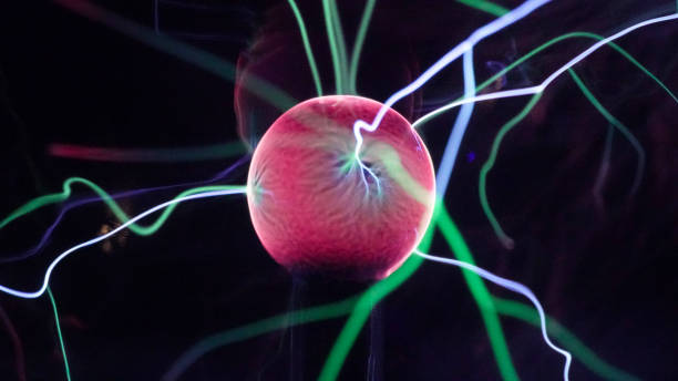 istock View of plasma ball with moving energy rays inside on black background. Abstract lightning in colors. Electricity in gas. 1293225426