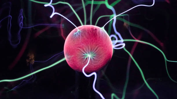 istock View of plasma ball with moving energy rays inside on black background. Abstract lightning in colors. Electricity in gas. 1293225432