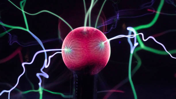 istock View of plasma ball with moving energy rays inside on black background. Abstract lightning in colors. Electricity in gas. 1293225446