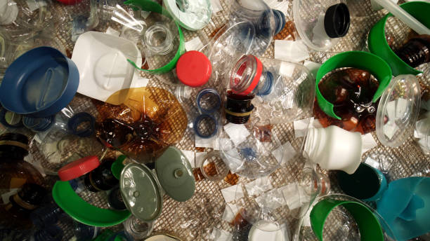 istock Plastic garbage from household on the table. Waste discarded, picked up from marine. City home trash made of plastic. Empty used bottles and cups create environmental pollution and ecological problem. 1293225496