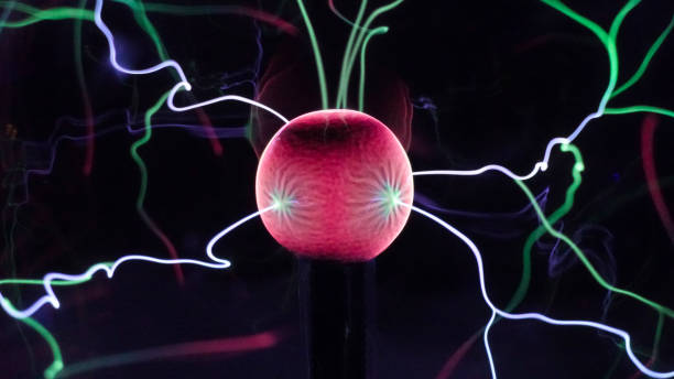 istock View of plasma ball with moving energy rays inside on black background. Abstract lightning in colors. Electricity in gas. 1293225552
