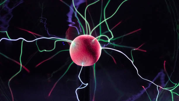 istock View of plasma ball with moving energy rays inside on black background. Abstract lightning in colors. Electricity in gas. 1293225555