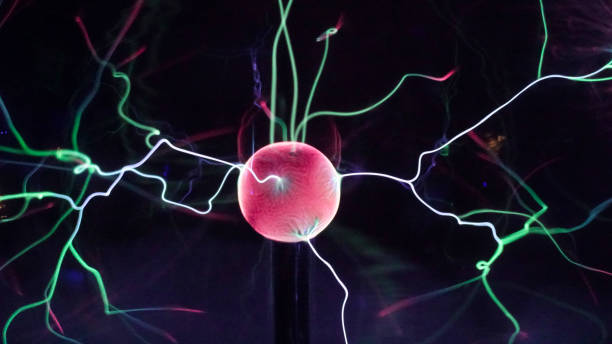 istock View of plasma ball with moving energy rays inside on black background. Abstract lightning in colors. Electricity in gas. 1293225562