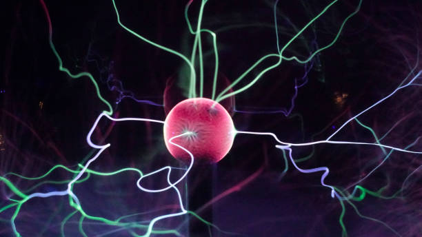 istock View of plasma ball with moving energy rays inside on black background. Abstract lightning in colors. Electricity in gas. 1293225566