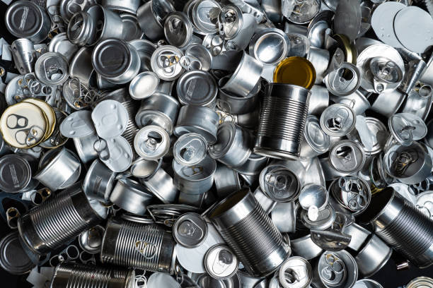 Large amount of metal tins, cans and jars for recycling. Aluminum metal food and drink sorted scraps. Steel packaging. Zero waste and recycle of domestic waste at home concept. No pollution. stock photo
