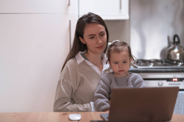 istock Young mother working at home with her daughter 1293227185