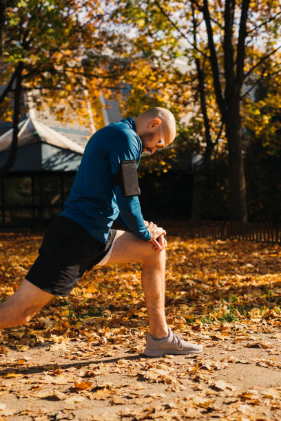 istock Fit Male Athlete Stretching his Legs after a Good Outdoors Workout 1293230237