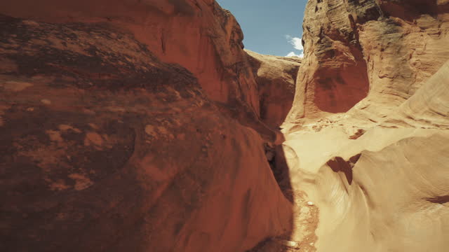 Summer travel in the Southwest USA: POV hiking in narrow canyon