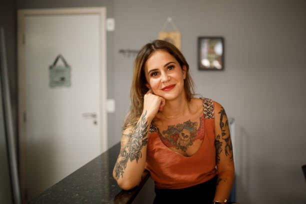 istock Smiling woman leaning on kitchen counter 1293247226