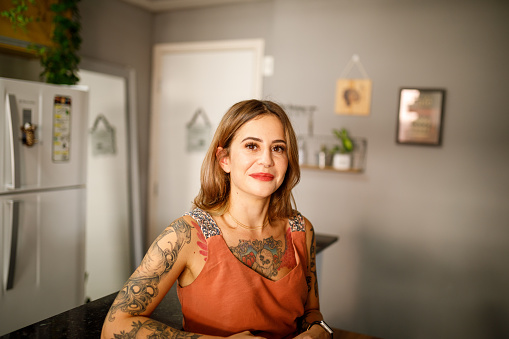 Portraits of tattooed a woman at home