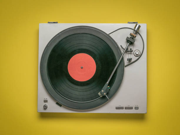 istock Vintage vinyl record player on yellow background. 1293247319