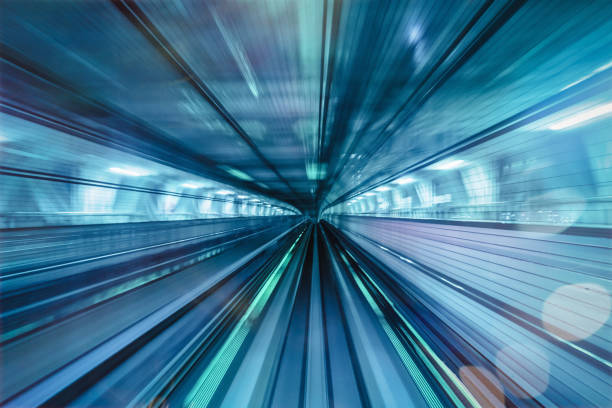 High Speed Elevated Train Motion Blur Abstract Tokyo Japan Motion blurred high speed elevated train speeding along the rails through an illuminated tunnel at night. Edited, Digital Composite Concept. Vanishing Point. Long Time Exposure. Odaiba, Tokyo, Japan, Asia city zoom out stock pictures, royalty-free photos & images