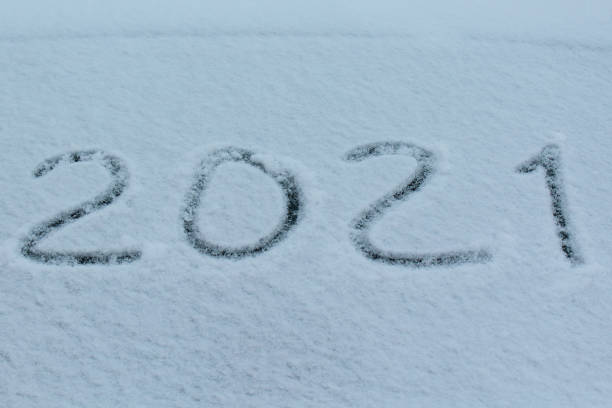 istock 2021 sign on snow on car windshield glass. Inscription 2021. 1293261492