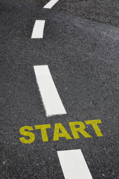 istock Start written on black asphalt road and white marking lines 1293263247