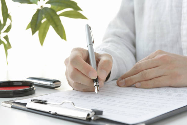 istock Japanese woman signing contract 1293266144