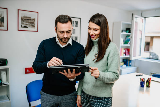 istock Young man and young woman using digital tablet in the classroom 1293273166