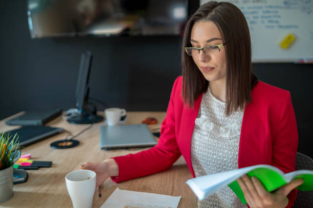 istock Smiling Elegant Female Drinking Coffee And Working From Home 1293274011