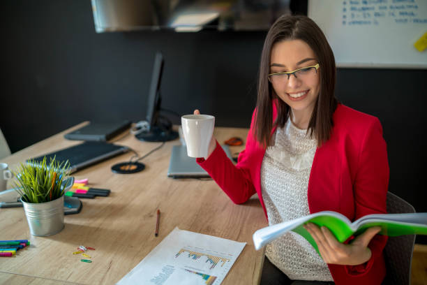 istock Smiling Elegant Female Drinking Coffee And Working From Home 1293274034
