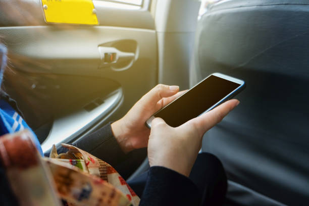 istock Blank screen smartphone use in hand sitting in taxi 1293274160