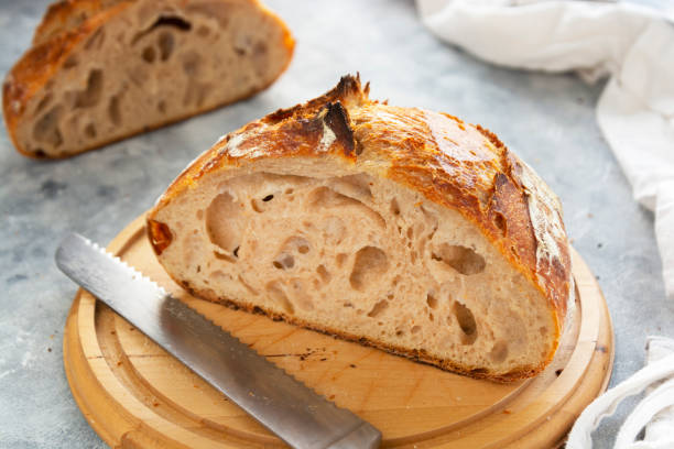 istock Sourdough bread slices, on a cutting board. Organic homemade bread. 1293274402