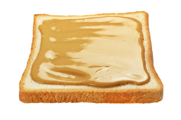 istock Slice of toasted bread with peanut butter isolated on white. 1293274419