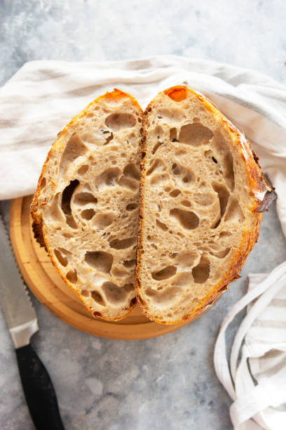 istock Sourdough bread slices, on a cutting board. Organic homemade bread. 1293275112