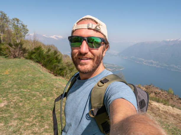 istock Cheerful young man taking a selfie portrait on mountain top 1293275523
