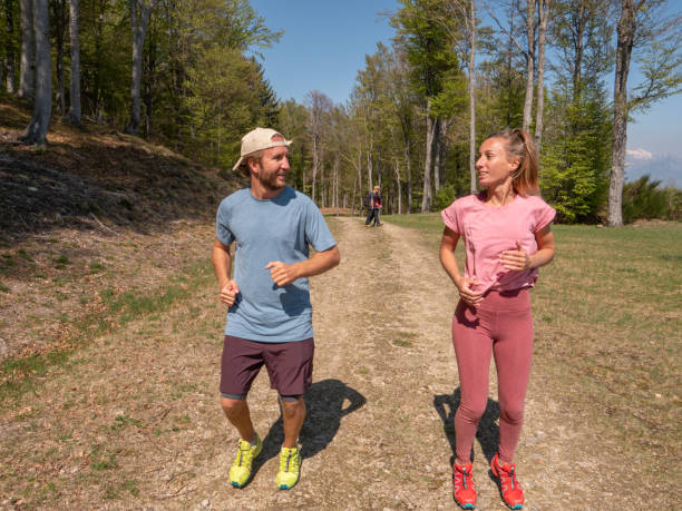 istock Sportive young couple jogging outdoors, trail running 1293275584