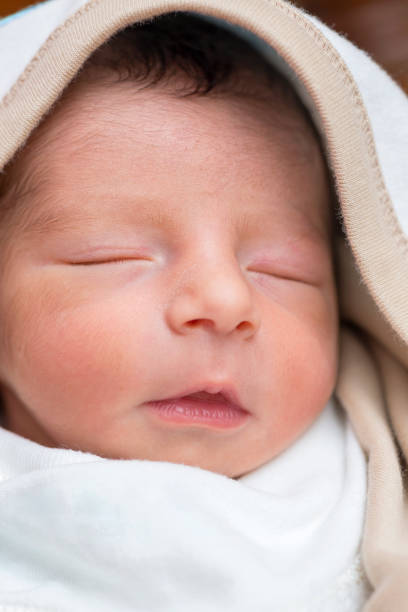 istock Newborn Baby Boy Face 1293276606