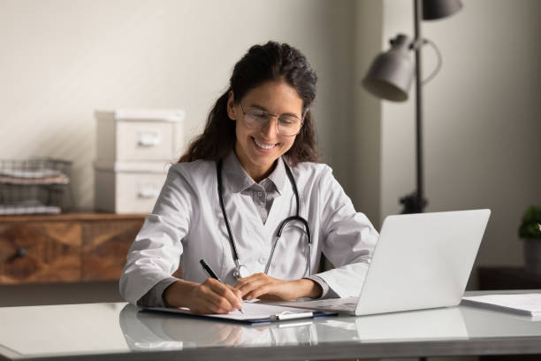istock Smiling female doctor work on computer in hospital 1293277470