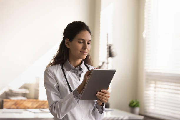 istock Female doctor work on modern tablet in clinic 1293277503