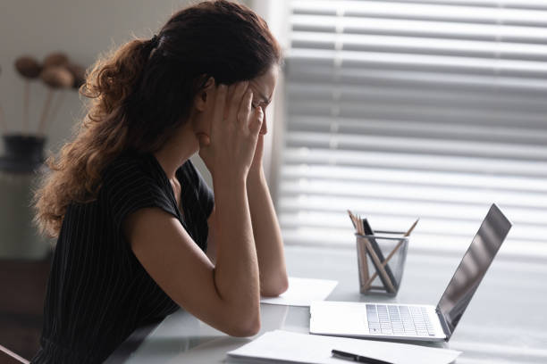 istock Tired woman suffer from headache overwhelmed with computer work 1293277520
