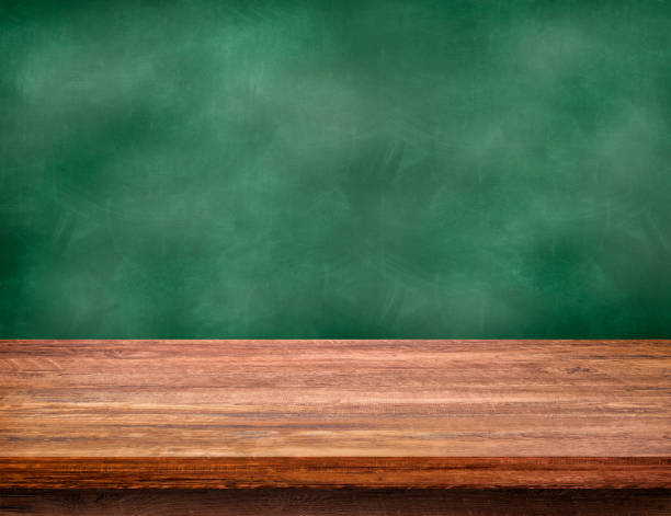 istock Empty space of Wooden table top with green chalkboard in background. 1293279977