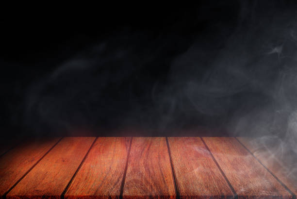 istock Empty space of Wooden table top with smoke or mist in black background. 1293279986