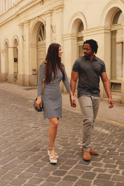 istock Couple holding hand, walking and casually talking 1293280232