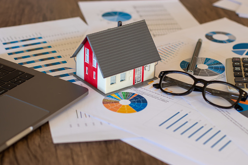 Miniature House on A Financial Graph