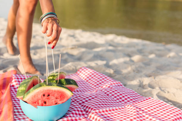 Getting a serving of delicious watermelon on a beach picnic