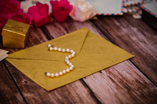 istock closed envelope with a pearl necklace on top 1293282807