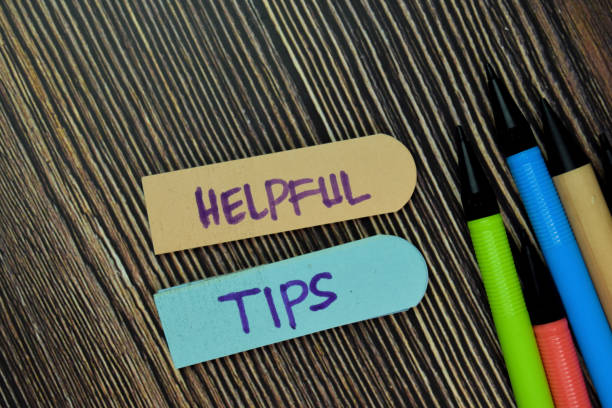 istock Helpful Tips write on sticky note and isolated on Wooden Table. Business Concept. Selective Focus on Helpful Tips text 1293283010