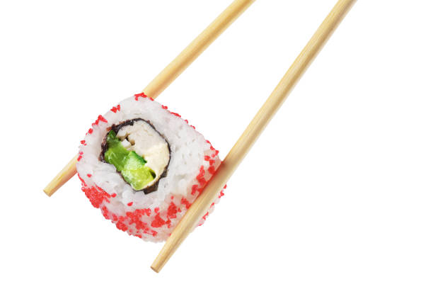 istock Chopsticks with sushi roll isolated on white background 1293283683