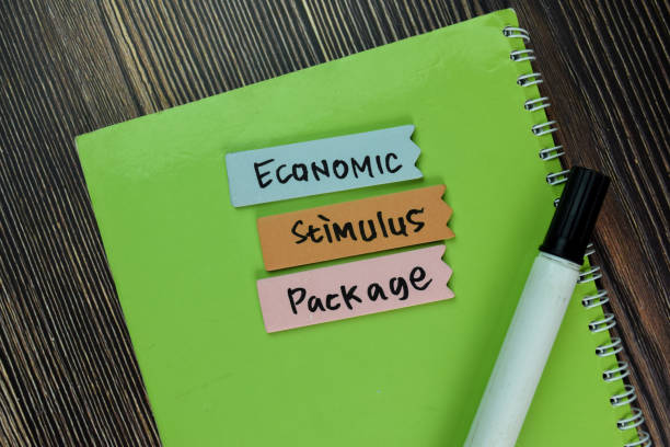 istock Economic Stimulus Package write on sticky note and isolated on Wooden Table. Finance Concept 1293283845