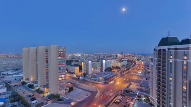 aktau city after sunset on the shore of the caspian sea day to night . kazakhstan - day to sunset imagens e fotografias de stock