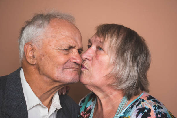 istock Adorable attractive elderly couple kissing 1293285106