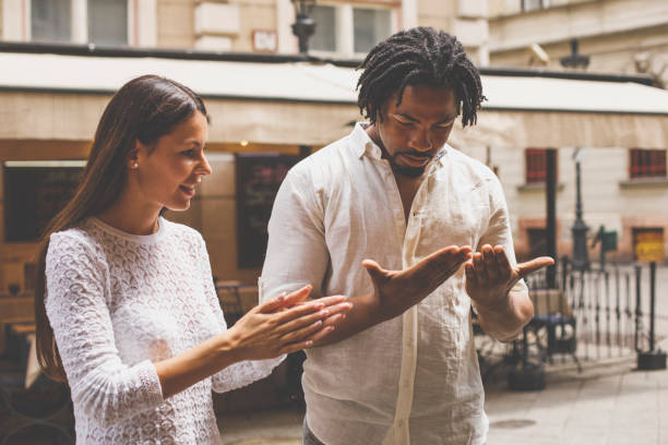 istock Couple looking at their hands while taking a walk at the city 1293285914